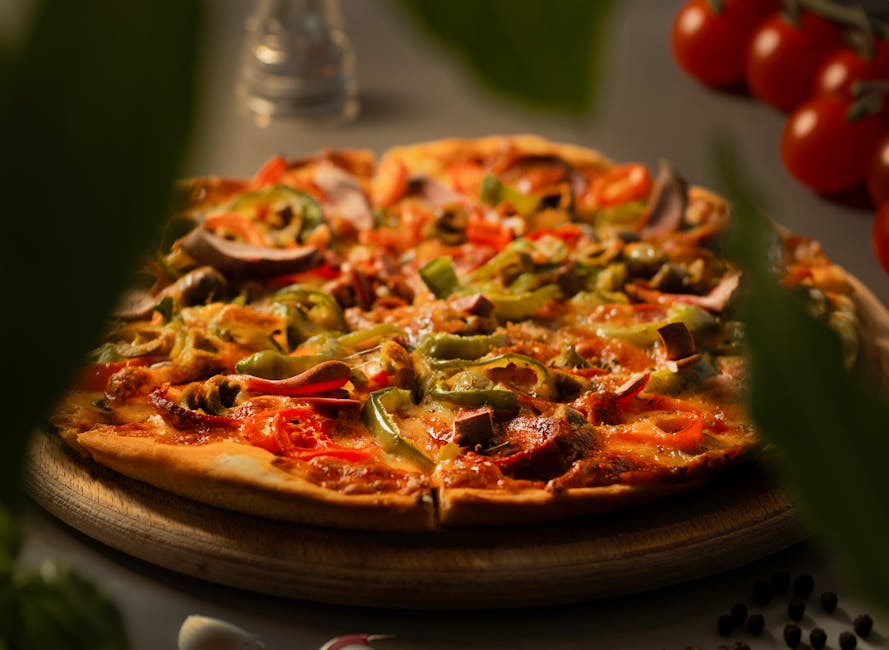 Close-up image of a vegetarian pizza topped with bell peppers, onions, and mushrooms