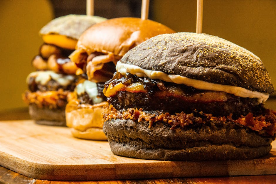 Mouthwatering close-up of gourmet burgers on a wooden board