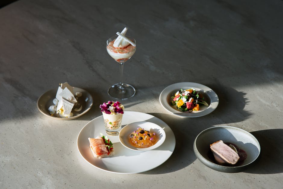 Luxurious gourmet food arrangement with diverse exquisite dishes beautifully plated on a table