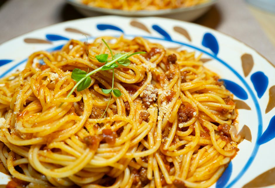 Close-up of savory spaghetti Bolognese garnished with fresh herbs